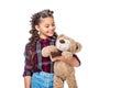 smiling schoolchild holding teddy bear