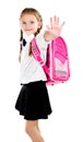 Smiling schoolgirl with backpack saying good bye