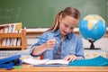 Smiling schoolgirl doing classwork Royalty Free Stock Photo