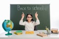 Smiling schoolkid pointing at chalkboard with Royalty Free Stock Photo