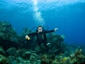 Smiling Scuba Diver descending on a Reef