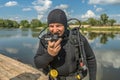 Smiling scuba diver with equipment ready for diving Royalty Free Stock Photo