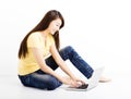 Smiling seated young woman with laptop