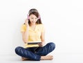 Smiling seated young woman with tablet pc