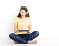 Smiling seated young woman with tablet pc