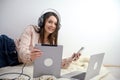 Smiling secretary answering phone calls and talking with customers, she is sitting at desk and working with a laptop. Royalty Free Stock Photo