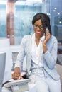 Smiling secretary talking on phone in modern office Royalty Free Stock Photo