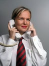 Smiling secretary with two phone