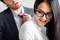 smiling, seductive businesswoman in eyeglasses near