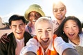 Smiling selfie of cheerful group of young people. Happy friends video call excited having fun. Interracial Royalty Free Stock Photo