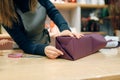 Smiling seller packing gift box in wrapping paper