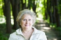 Smiling senior aged woman in forest