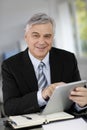 Smiling senior businessman with tablet Royalty Free Stock Photo