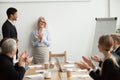 Smiling senior businesswoman boss and team clapping hands at mee