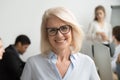Smiling senior businesswoman wearing glasses portrait with busin Royalty Free Stock Photo