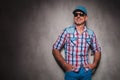 Smiling senior casual man wearing baseball hat looking away