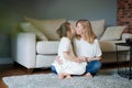 Smiling senior caucasian grandmother and little girl are relaxing at home Royalty Free Stock Photo