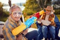 Senior couple on crazy vacation  playing with water gun Royalty Free Stock Photo