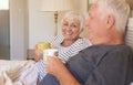 Smiling senior couple drinking coffee together in bed Royalty Free Stock Photo