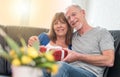 Smiling senior couple exchanging gift, light effect