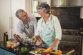 Smiling senior couple looking at each other while standing in kitchen Royalty Free Stock Photo