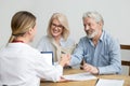 Smiling senior couple and realtor handshaking making real estate Royalty Free Stock Photo