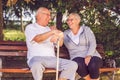 Smiling senior couple sitting on a park bench