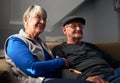 Smiling Senior Couple Sitting On Sofa At Home Watching Television Together Royalty Free Stock Photo