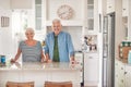 Smiling senior couple standing at their kitchen counter at home Royalty Free Stock Photo