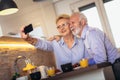 Senior couple taking selfie at home Royalty Free Stock Photo