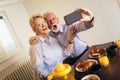 Senior couple taking selfie at home Royalty Free Stock Photo