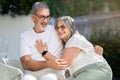 Smiling senior european husband and wife in white t-shirts have fun, enjoy spare time Royalty Free Stock Photo