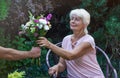 Elderly woman get a beautiful bouquet of field flowers. Royalty Free Stock Photo