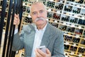 smiling senior man choosing wine at supermarket Royalty Free Stock Photo