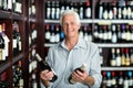 Smiling senior man choosing wine Royalty Free Stock Photo