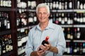 Smiling senior man choosing wine Royalty Free Stock Photo