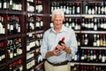 Smiling senior man choosing wine Royalty Free Stock Photo