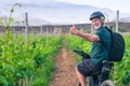 Smiling senior man enjoying healtlhy lifestyle riding in a vineyard with his bicycle. Elderly bearded man wearing sport helmet in Royalty Free Stock Photo