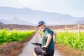 Smiling senior man enjoying healtlhy lifestyle riding in a vineyard at sunset light with his bicycle. Elderly bearded man wearing Royalty Free Stock Photo