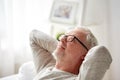 Smiling senior man in glasses relaxing on sofa Royalty Free Stock Photo