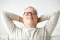 Smiling senior man in glasses relaxing on sofa Royalty Free Stock Photo