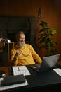 Smiling senior man looking at laptop screen during work or rest at home office Royalty Free Stock Photo