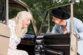 smiling senior man opening car door in front Royalty Free Stock Photo