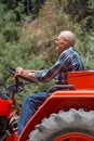 Smiling, Senior Man Operating a Tractor Royalty Free Stock Photo