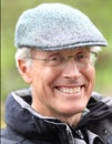 Smiling Senior Man Outdoors with Glasses and Cap Royalty Free Stock Photo