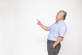 Senior man pointing towards something, Happy Asian old man showing to copy space blank space isolated on white background Royalty Free Stock Photo