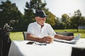 Smiling senior man relaxing after playing a round of golf Royalty Free Stock Photo