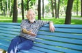 Smiling senior man sitting on the bench in park Royalty Free Stock Photo