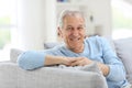 Smiling senior man on sofa