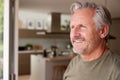 Smiling Senior Man Standing And Looking Out Of Kitchen Door Royalty Free Stock Photo